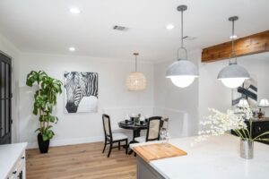 Bright dining area with zebra artwork and modern lighting.