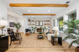Bright, modern living room with wooden beams and cozy seating.