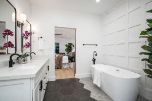Bright modern bathroom with a freestanding tub and hexagonal floor tiles.