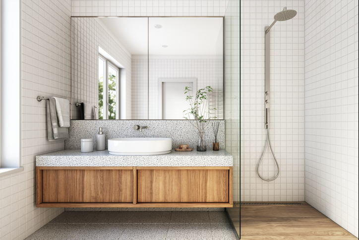 Bathroom with wooden floating vanity and glass shower